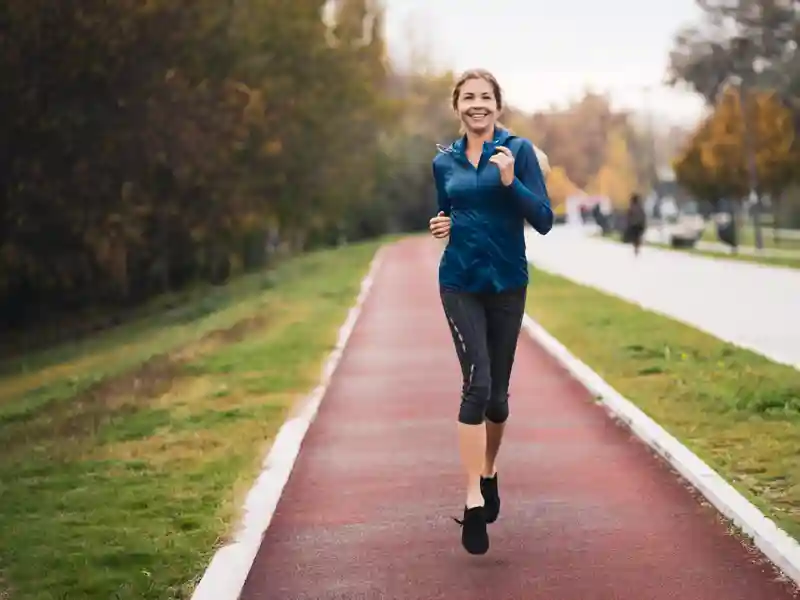A women jogging on a track.