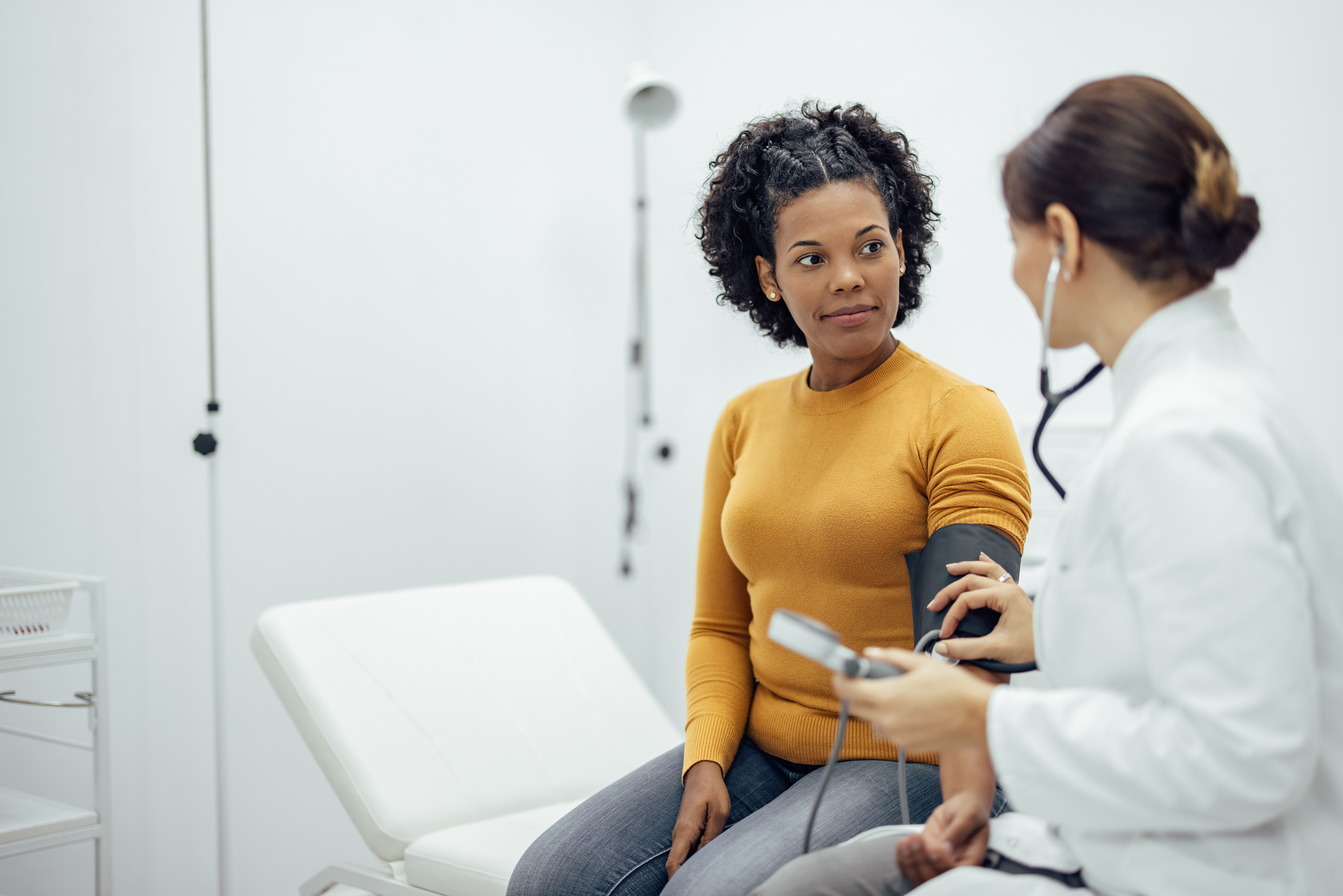 A doctor taking a patient's blood pressure.